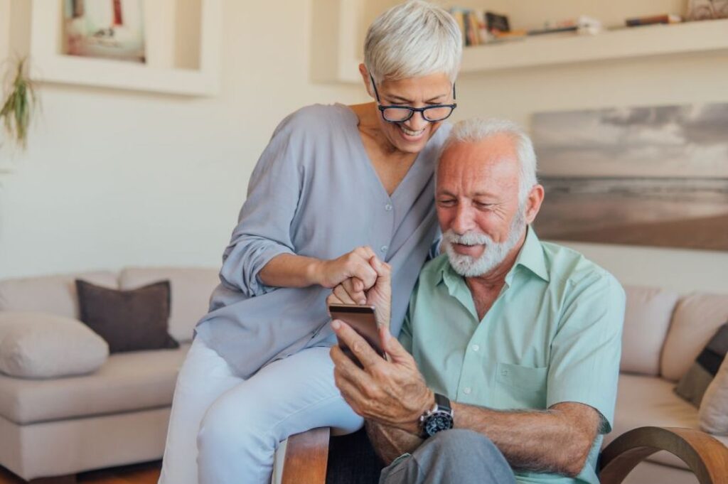 senior couple browsing smartphone