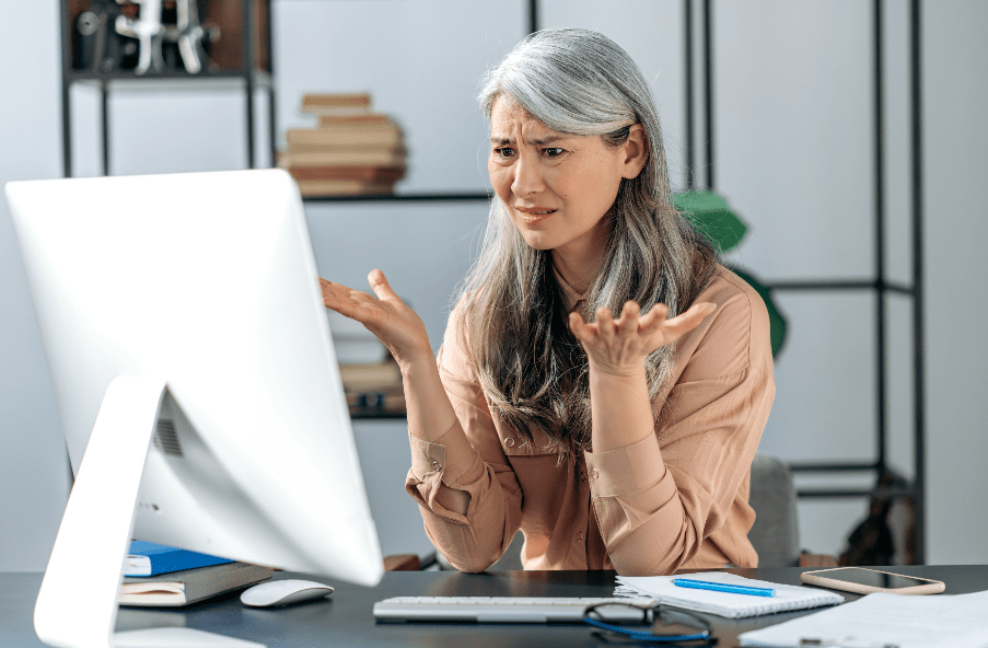 frustrated woman at computer wants to start writing her memoir